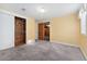 Bedroom featuring neutral walls, carpet flooring, and a closet with shelving for storage at 5285 E Iliff Ave, Denver, CO 80222