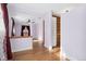 Open bedroom space with wood floors and natural light; adjacent to a wooden-style closet at 5285 E Iliff Ave, Denver, CO 80222