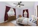 Comfortable bedroom with wood floors, natural light, neutral colors, and a ceiling fan at 5285 E Iliff Ave, Denver, CO 80222