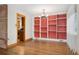 Dining room featuring hardwood floors, custom shelving, and natural light at 5285 E Iliff Ave, Denver, CO 80222