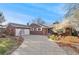 Charming brick home featuring a spacious driveway, attached garage, and beautifully landscaped front yard at 5285 E Iliff Ave, Denver, CO 80222