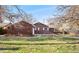 Charming brick home with a well-manicured front yard and mature trees at 5285 E Iliff Ave, Denver, CO 80222