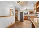 Spacious kitchen with light oak cabinets, stainless steel appliances, hardwood floors, and a view of the backyard at 5285 E Iliff Ave, Denver, CO 80222