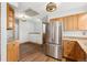 Kitchen with stainless steel refrigerator and wood cabinets at 5285 E Iliff Ave, Denver, CO 80222