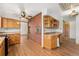 Spacious kitchen with brick wall, built in oven, and wooden cabinets at 5285 E Iliff Ave, Denver, CO 80222