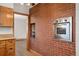 Kitchen featuring brick accent wall and built in oven at 5285 E Iliff Ave, Denver, CO 80222