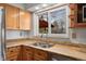 Kitchen sink featuring wood cabinets and countertops at 5285 E Iliff Ave, Denver, CO 80222