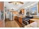 Bright kitchen features stainless steel appliances, gas range, wood cabinets, and granite countertops at 5285 E Iliff Ave, Denver, CO 80222