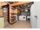 Basement laundry room with washer, dryer, shelving and utility sink at 5285 E Iliff Ave, Denver, CO 80222