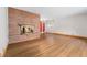 Bright living room with hardwood floors and a stone fireplace, offering a cozy and inviting atmosphere at 5285 E Iliff Ave, Denver, CO 80222