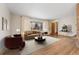 Bright living room showcasing large window, hardwood floors, and cozy furniture at 5285 E Iliff Ave, Denver, CO 80222