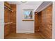 A cedar-lined walk-in closet with a window, hardwood floor, and modern organizers at 5285 E Iliff Ave, Denver, CO 80222