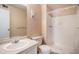 Bright bathroom with a vanity sink, toilet, and stand up shower with tile surround at 13241 E Asbury Dr # 203, Aurora, CO 80014