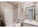 Bright bathroom featuring a tub-shower combo, vanity with sink, and classic tile at 13241 E Asbury Dr # 203, Aurora, CO 80014
