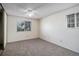 This bedroom features neutral carpet, two windows with blinds and a ceiling fan with light at 13241 E Asbury Dr # 203, Aurora, CO 80014