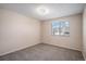 Comfortable bedroom with neutral carpet and a window offering natural light, creating a serene atmosphere at 13241 E Asbury Dr # 203, Aurora, CO 80014