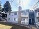 Attractive condo showcasing balconies and stone features, set within a neatly kept lawn area at 13241 E Asbury Dr # 203, Aurora, CO 80014