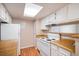 Efficient kitchen space featuring white appliances, wood-look countertops, and ample cabinet storage at 13241 E Asbury Dr # 203, Aurora, CO 80014