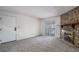 Inviting living area features a stone fireplace, neutral carpet, and a sliding glass door at 13241 E Asbury Dr # 203, Aurora, CO 80014