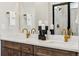 Modern bathroom with dual sinks, marble countertops, gold faucets, and a tiled glass shower at 17125 W 92Nd Loop, Arvada, CO 80007