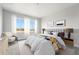 Comfortable bedroom featuring a large bed, soft lighting, and scenic views from the bright windows at 17125 W 92Nd Loop, Arvada, CO 80007
