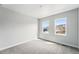 Bright bedroom featuring two windows and neutral carpet, providing a serene and inviting space at 17125 W 92Nd Loop, Arvada, CO 80007