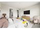Well-lit bedroom with a plush bed, neutral tones, and a dresser with a sleek television at 17125 W 92Nd Loop, Arvada, CO 80007