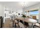 Open concept design with modern kitchen featuring an island, dining area, and outdoor access at 17125 W 92Nd Loop, Arvada, CO 80007