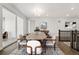 Bright dining room featuring a stylish chandelier, modern furniture, and access to outdoor space at 17125 W 92Nd Loop, Arvada, CO 80007