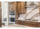 Gourmet kitchen with built-in microwave and oven paired with elegant wood cabinets and light countertops at 17125 W 92Nd Loop, Arvada, CO 80007