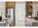 Kitchen boasts stainless steel appliances, stone countertops, and matching wood cabinets at 17125 W 92Nd Loop, Arvada, CO 80007