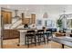 Modern kitchen with wood cabinets, island seating, decorative backsplash, and stainless steel appliances at 17125 W 92Nd Loop, Arvada, CO 80007
