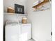Bright laundry area with a washer, dryer, decor, and storage; perfect for a modern home at 17125 W 92Nd Loop, Arvada, CO 80007