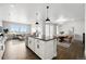 Spacious open concept living area with a modern kitchen island, dining area, and bright living room at 17125 W 92Nd Loop, Arvada, CO 80007