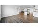 Open-concept living room with hardwood flooring and views of the modern kitchen and staircase at 17125 W 92Nd Loop, Arvada, CO 80007
