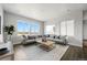 Bright and airy living room featuring a comfortable sofa, modern coffee table, and large windows at 17125 W 92Nd Loop, Arvada, CO 80007