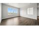 Bright living room featuring large windows, dark hardwood floors, and plenty of space to relax at 17125 W 92Nd Loop, Arvada, CO 80007