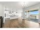 Spacious living room with hardwood floors, lots of natural light, and an open floor plan leading to kitchen at 17125 W 92Nd Loop, Arvada, CO 80007