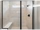 Glass enclosed shower with built in bench and chrome fixtures at 17125 W 92Nd Loop, Arvada, CO 80007