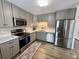 Modern kitchen with gray cabinets and stainless steel appliances at 11604 Community Center Dr # 12, Northglenn, CO 80233