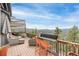 Expansive deck offers multiple seating areas with panoramic views of surrounding mountains at 3961 Mossy Rock Ln, Evergreen, CO 80439