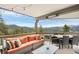Outdoor living at its finest with comfortable seating and panoramic mountain vistas at 3961 Mossy Rock Ln, Evergreen, CO 80439