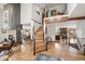 Grand entryway with soaring ceilings, hardwood floors, a striking staircase, and views into the dining room and kitchen at 3961 Mossy Rock Ln, Evergreen, CO 80439