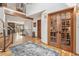 Welcoming foyer with hardwood floors, natural lighting, staircase, and view to other living spaces at 3961 Mossy Rock Ln, Evergreen, CO 80439