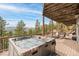 Relax in this elevated hot tub while overlooking scenic mountain views from the spacious deck at 3961 Mossy Rock Ln, Evergreen, CO 80439