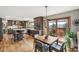 Gourmet kitchen with an eat-in island, stainless steel appliances, and an adjacent dining area with scenic outdoor views at 3961 Mossy Rock Ln, Evergreen, CO 80439