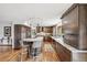 Bright kitchen with dark wood cabinetry, marble countertops, pendant lighting, and stainless steel appliances at 3961 Mossy Rock Ln, Evergreen, CO 80439