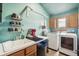 Convenient laundry room includes a utility sink, workspace, and modern washer/dryer at 3961 Mossy Rock Ln, Evergreen, CO 80439