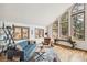 Bright living room with oversized windows and natural light, featuring a mountain view at 3961 Mossy Rock Ln, Evergreen, CO 80439