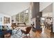 Bright living room with high ceilings, modern fireplace, stylish furnishings, and great natural light at 3961 Mossy Rock Ln, Evergreen, CO 80439